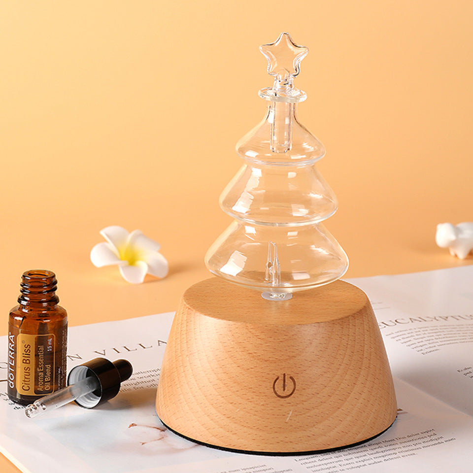 Wood aroma diffuser with clear glass tree-like top and round light wood base