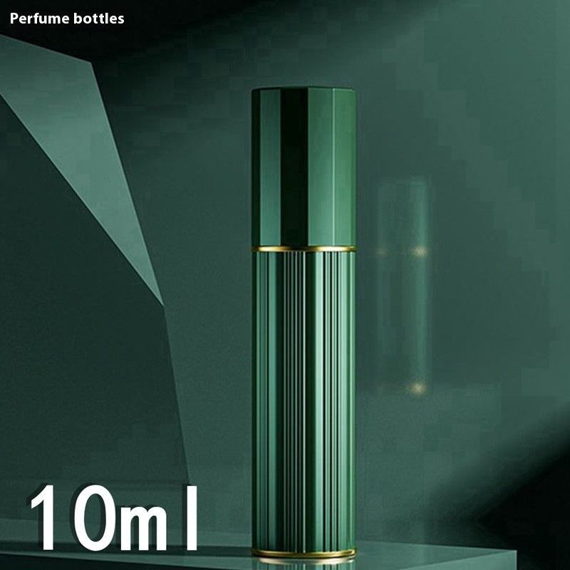Green travel perfume atomiser with ribbed metal body, gold trim, and capped top