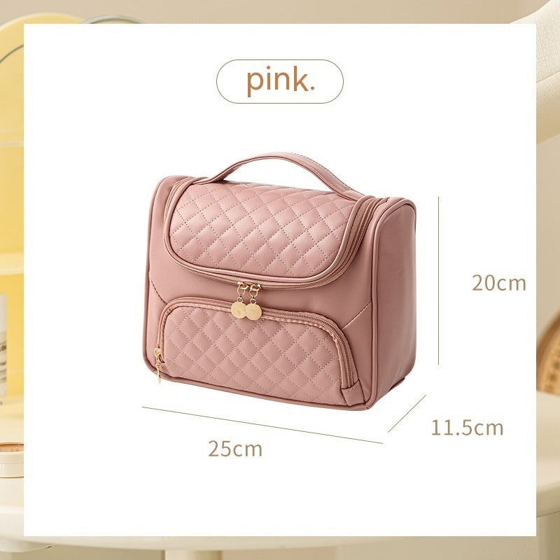 Rose pink vanity bag with quilted lid and front zip pouch, gold-tone zipper pulls