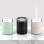 Set of three candle-style aroma diffuser jars in mint, black, and pink