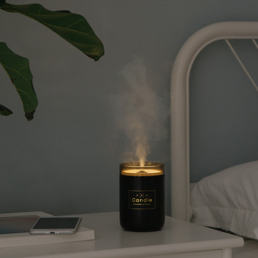 Black candle-style aroma diffuser jar releasing light mist