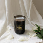 Black candle-style aroma diffuser jar with clear lid and gold logo