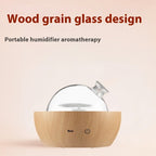 Naqsh Nebula glass aroma diffuser with light wood grain base and clear glass globe