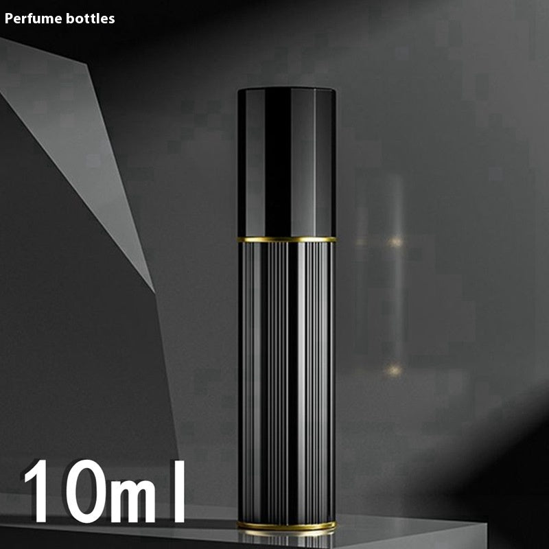 Dark green travel perfume atomiser with ribbed metal body and gold-toned collar