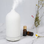 White ceramic aroma diffuser with rounded top and control buttons on base