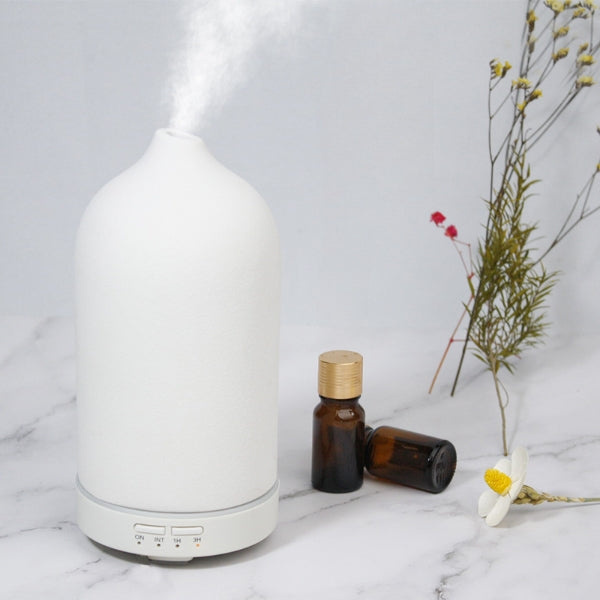 White ceramic aroma diffuser with rounded top and control buttons on base