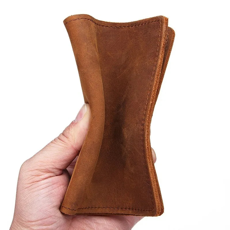 Leather passport cover held upright, warm tan exterior with stitched bottom edge