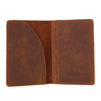 Open leather passport cover with card slots and center seam, dark brown with stitched border