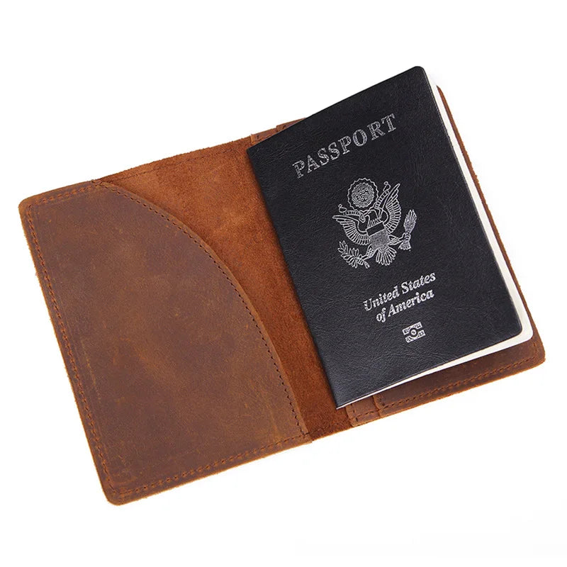 Leather passport cover holding a passport card, tan-brown exterior with stitched trim