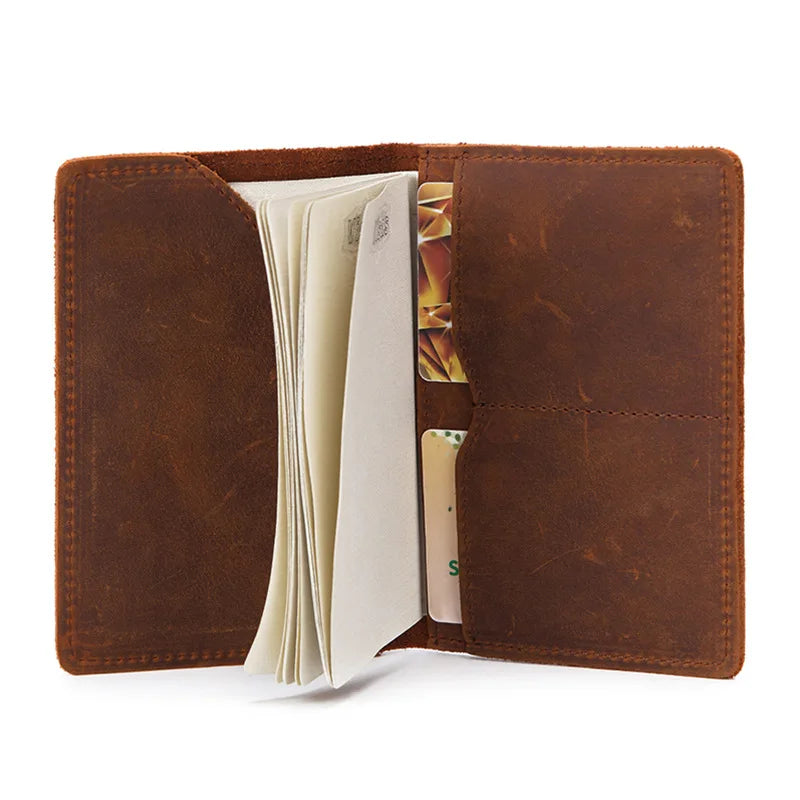Open leather passport cover with card and document pockets, tan-brown interior view