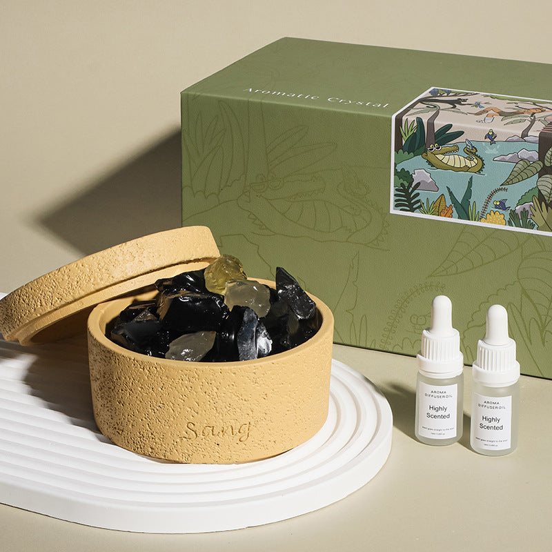 Natural stone crystal diffuser with sand-colored bowl and dark crystals, includes two bottles