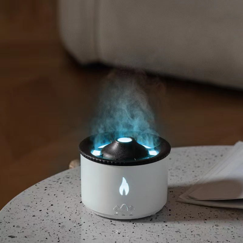 White aroma diffuser with blue LED glow and mist rising from the top