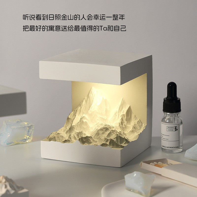 Aromatherapy essential oil lamp with mountain cutout and glass dropper bottle