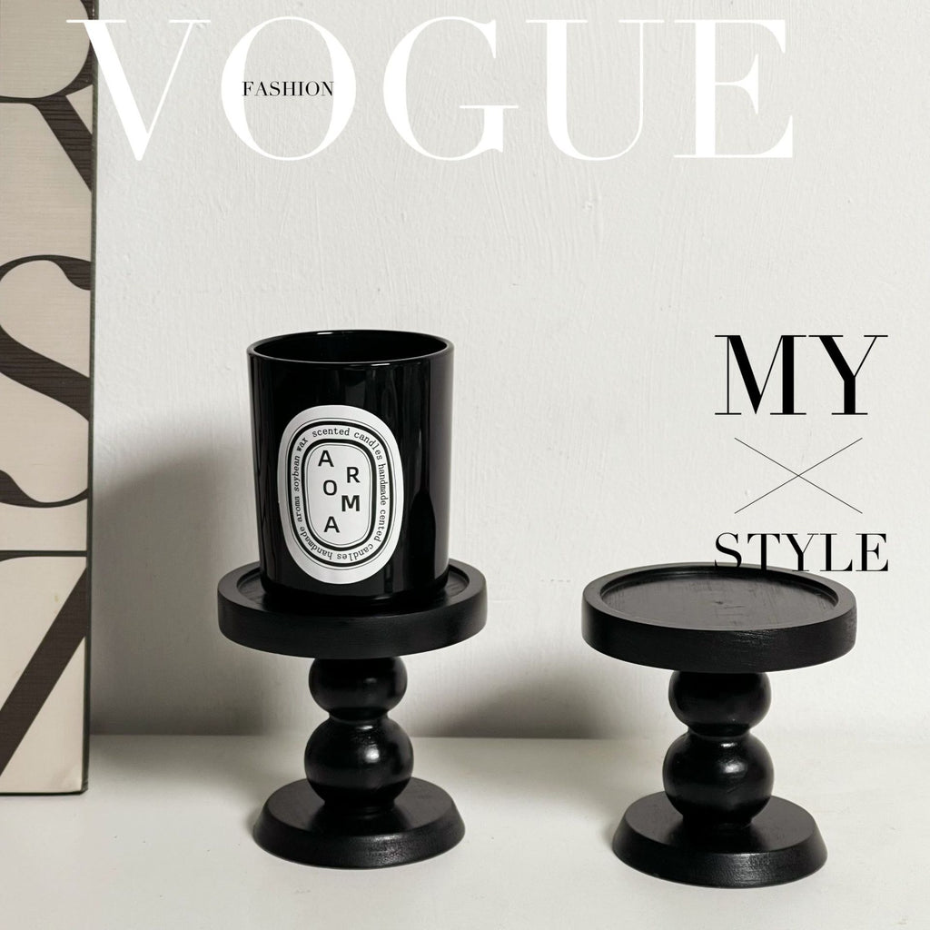 Black round scent tray with pedestal base, glossy candle cup on top