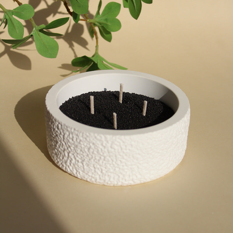 Stone crystal diffuser with black wax insert and three wicks, white textured base