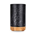 Black mini aroma diffuser with light wood base, forest tree silhouette pattern