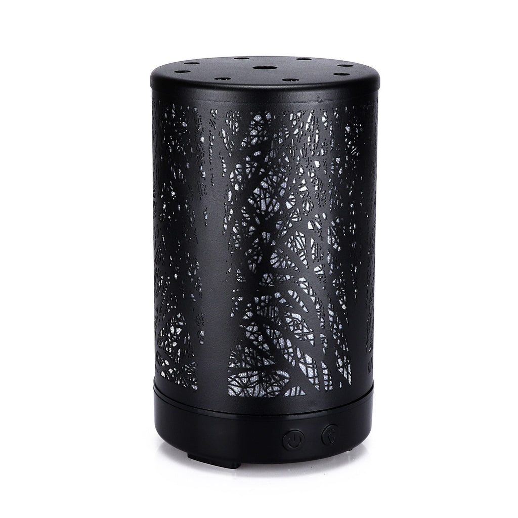 Black mini aroma diffuser with etched forest pattern, circular control buttons