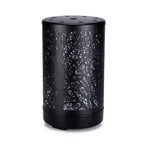Black mini aroma diffuser with etched forest pattern, circular control buttons