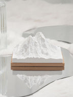Natural stone crystal diffuser with white mountain insert on wooden base