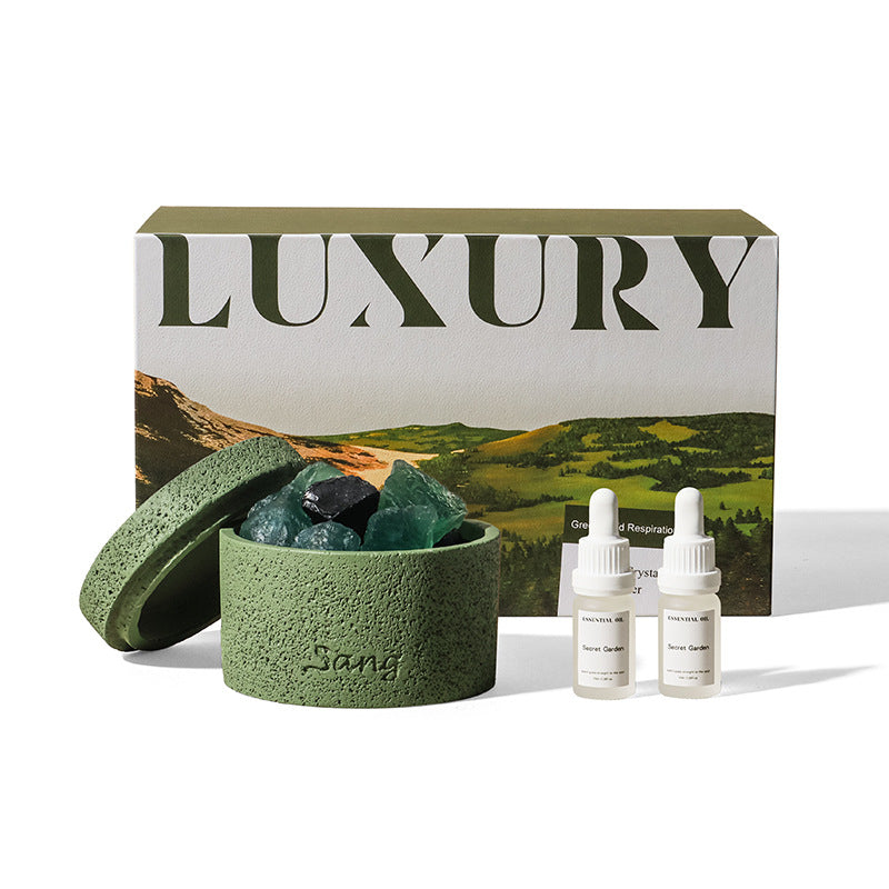 Natural stone crystal diffuser with green bowl, teal crystals, and two essential oil bottles