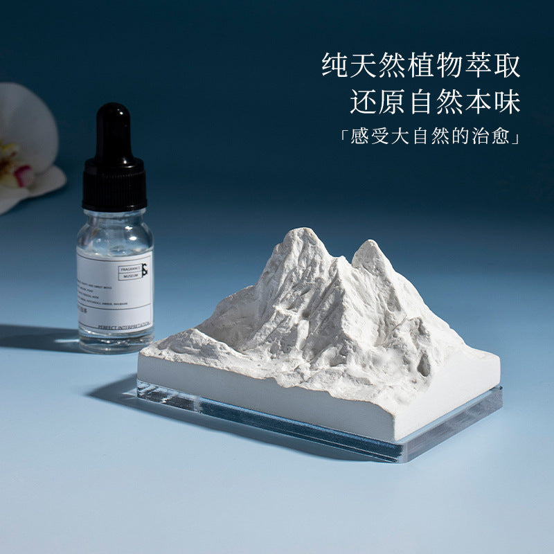 Natural stone crystal diffuser with white mountain-like insert and dropper bottle