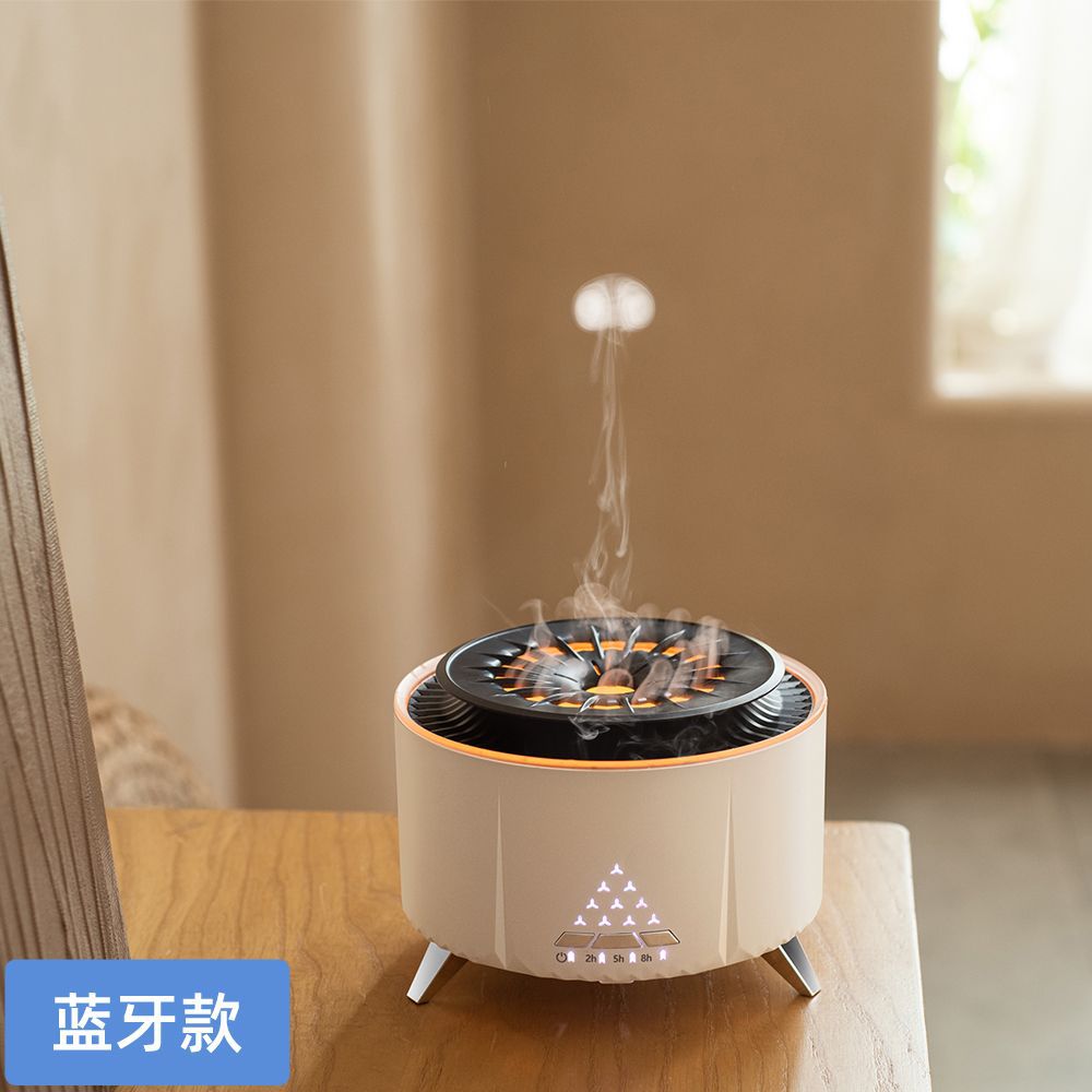 White volcano aroma diffuser with faux flame light and round top, on three legs.