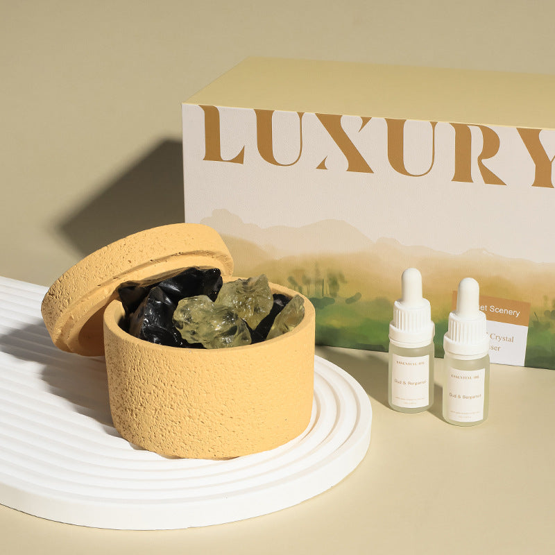 Stone crystal diffuser with beige holder and mixed green-black crystals, plus two dropper bottles