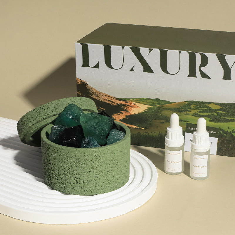Natural stone crystal diffuser with green bowl and teal crystals, paired with two bottles