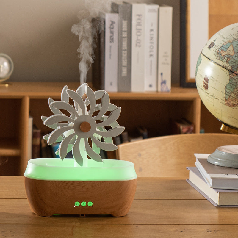 Green water-drop aroma diffuser with flower-shaped top, mist vents and glowing indicator LEDs