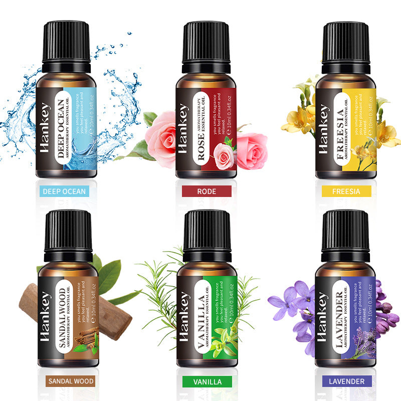 Six essential oil bottles with black caps, labeled Deep Ocean, Rose, Freesia, and more