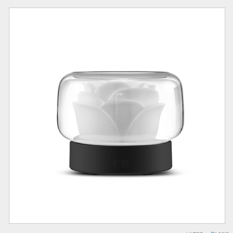 Mini rose aroma diffuser with black base and clear dome over frosted rose diffuser insert.
