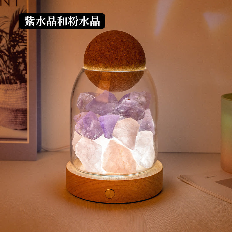 Crystal diffuser night light with purple and clear crystal chunks on wooden base