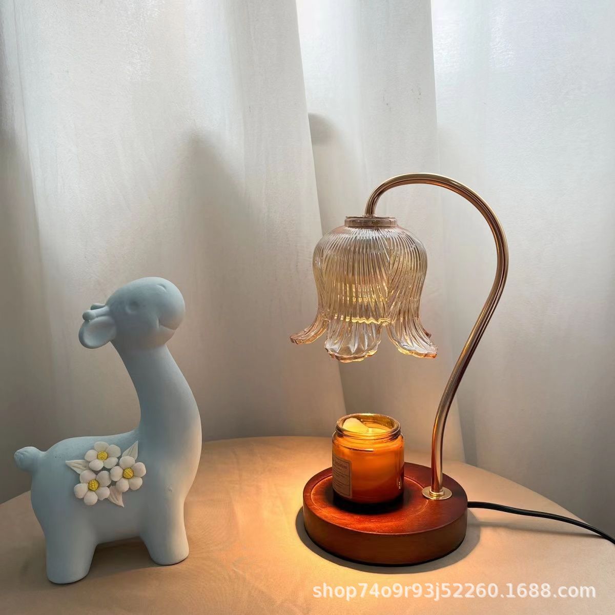 Wood-grain aroma diffuser with warm-lit bell glass shade and amber candle jar on base