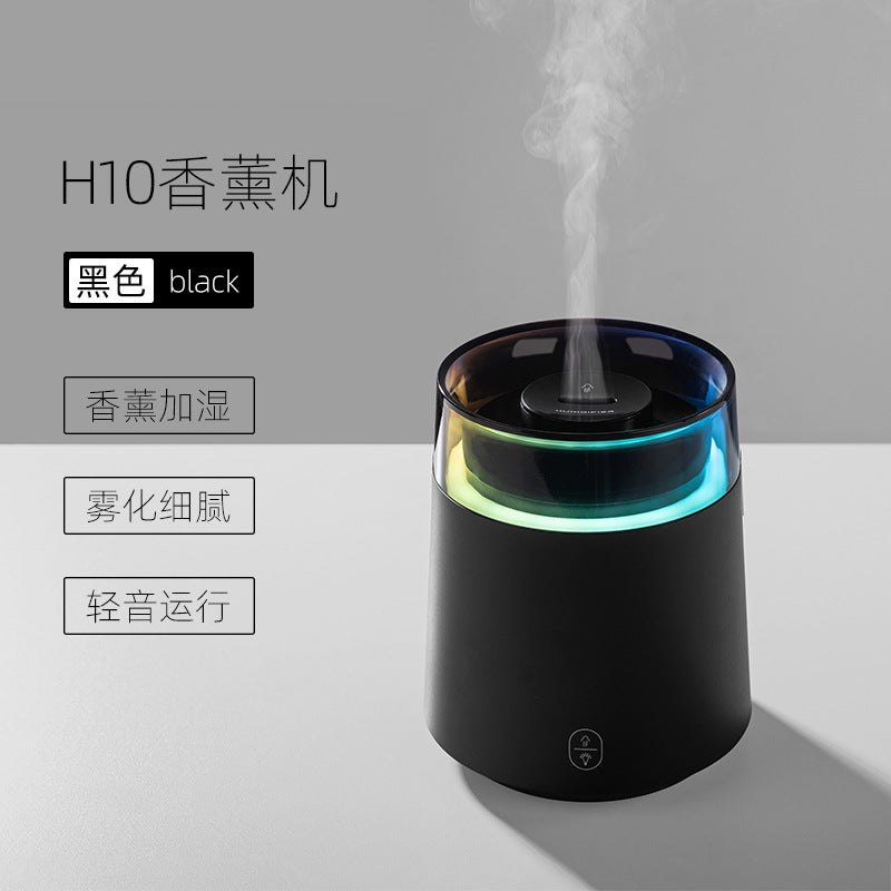 Black aroma diffuser night light with glowing blue ring and mist from top
