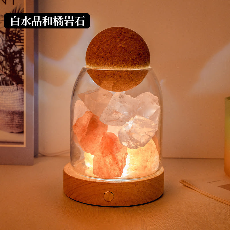 Crystal diffuser night light with white and orange crystal chunks on wooden base