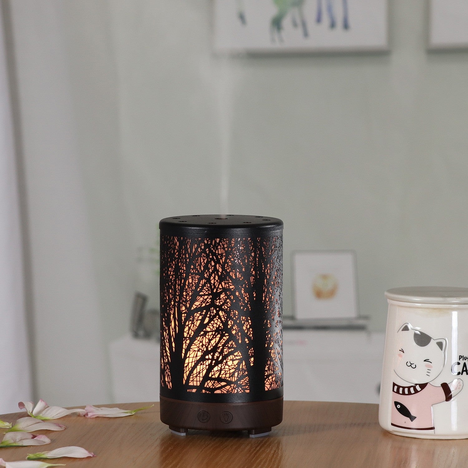 Mini aroma diffuser with dark base, warm amber forest glow, round top vent holes