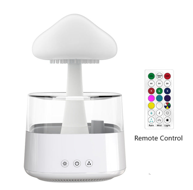 White cloud-top aroma diffuser with remote control handset beside it