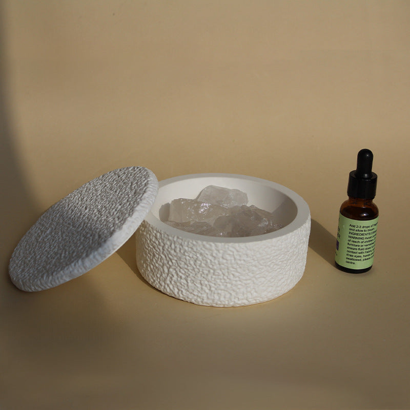 Stone crystal diffuser with light gray crystals in a white textured base and lid