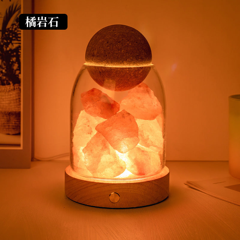 Salt stone crystal diffuser night light with warm orange/red crystal pieces in glass dome