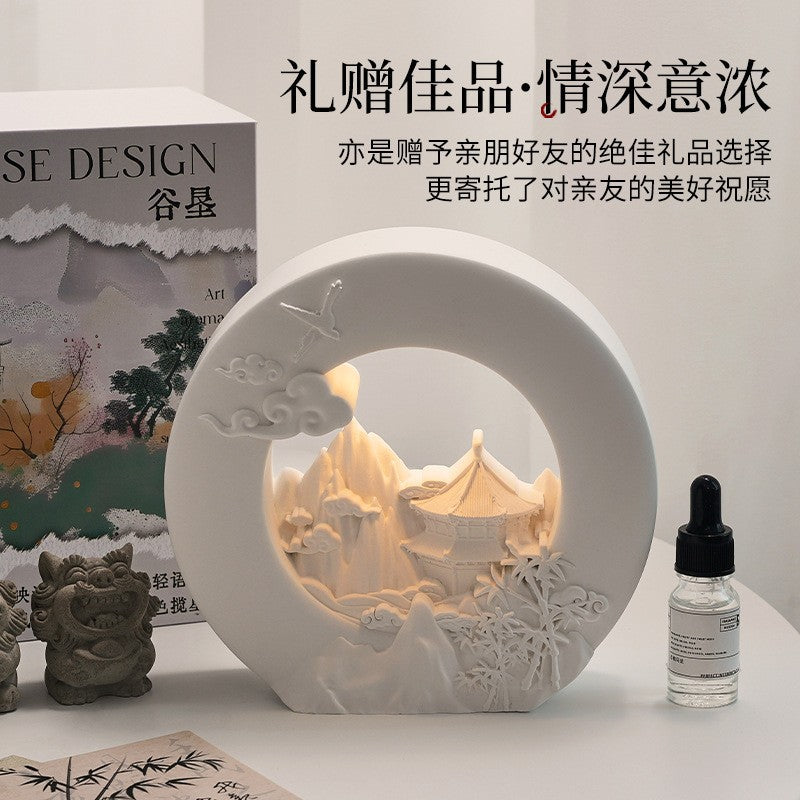 White decorative aromatherapy lamp with angel scene and small essential oil bottle