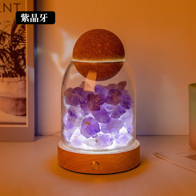 Crystal diffuser night light with purple crystal chunks and glowing salt-stone cap on wooden base