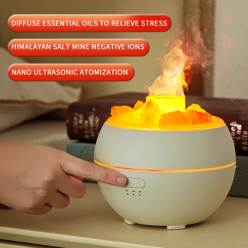 White flame-style salt diffuser with glowing top and user hand nearby