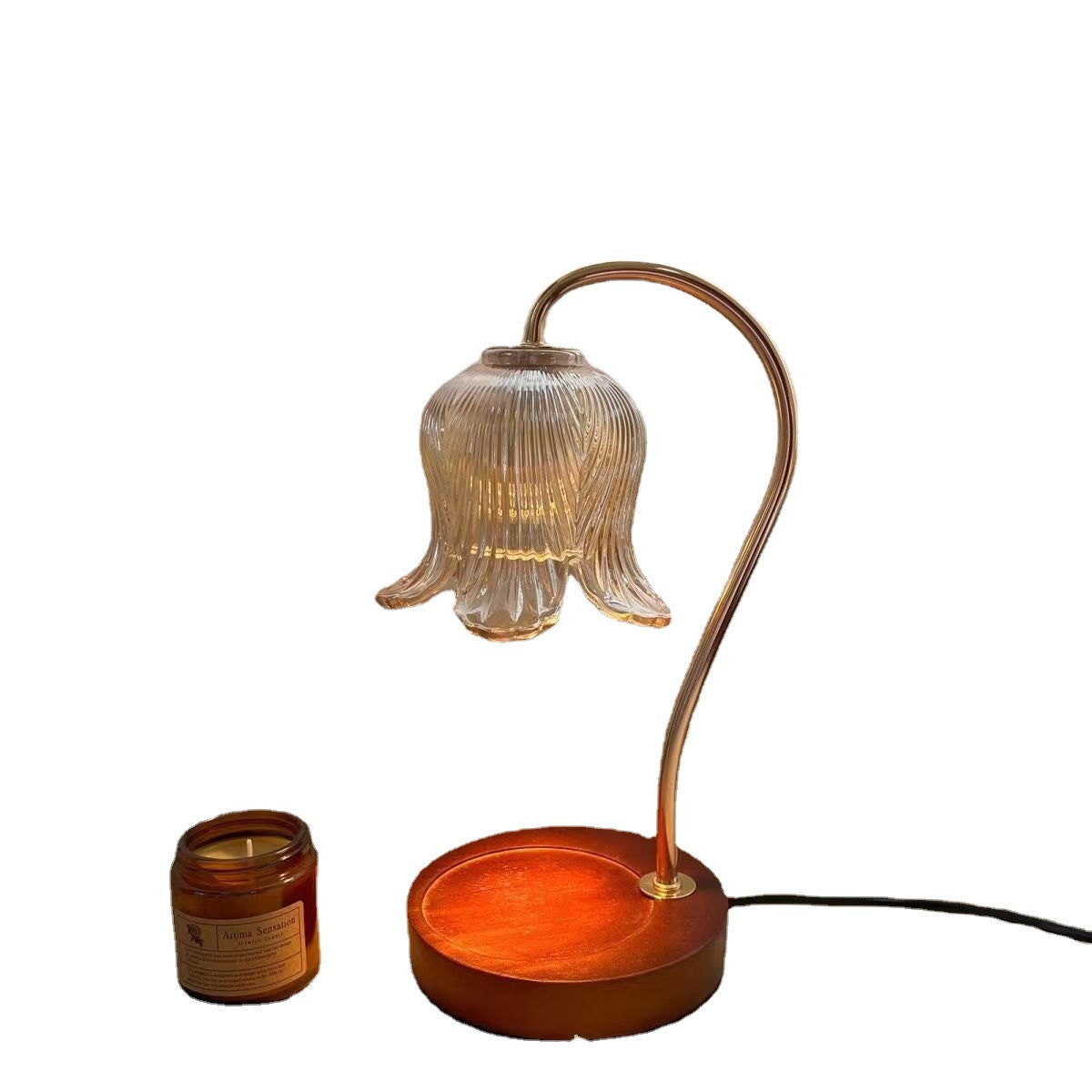 Aroma diffuser on wood-grain base with glowing bell glass shade and amber candle jar
