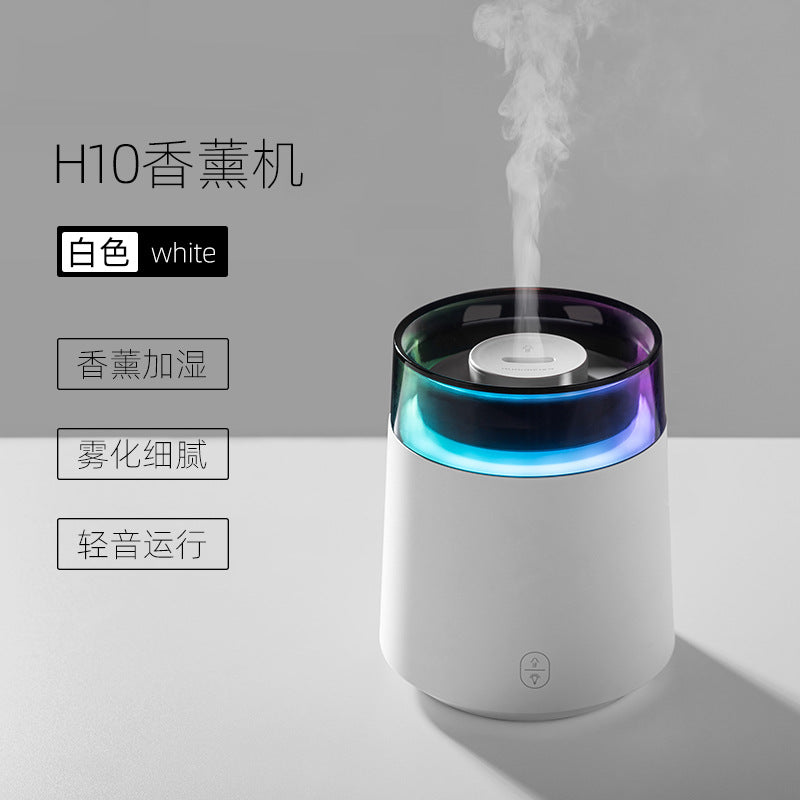 White aroma diffuser night light with glowing blue ring and mist from top