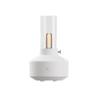 White aroma diffuser with clear glass tube and warm glowing filament