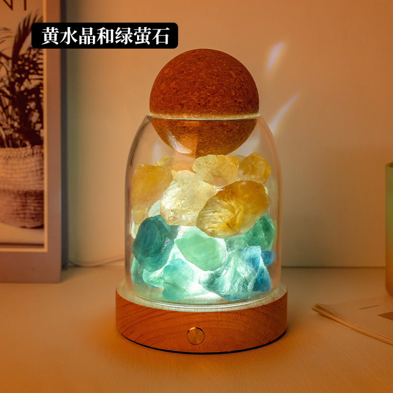 Crystal diffuser night light with green and yellow crystal chunks on wooden base