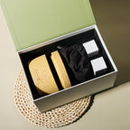 Natural stone crystal diffuser set in open box with sand-colored stones and two bottles