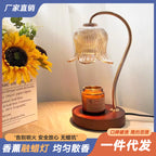 Wood-grain aroma diffuser with warm-lit bell glass shade, amber jar, and round base