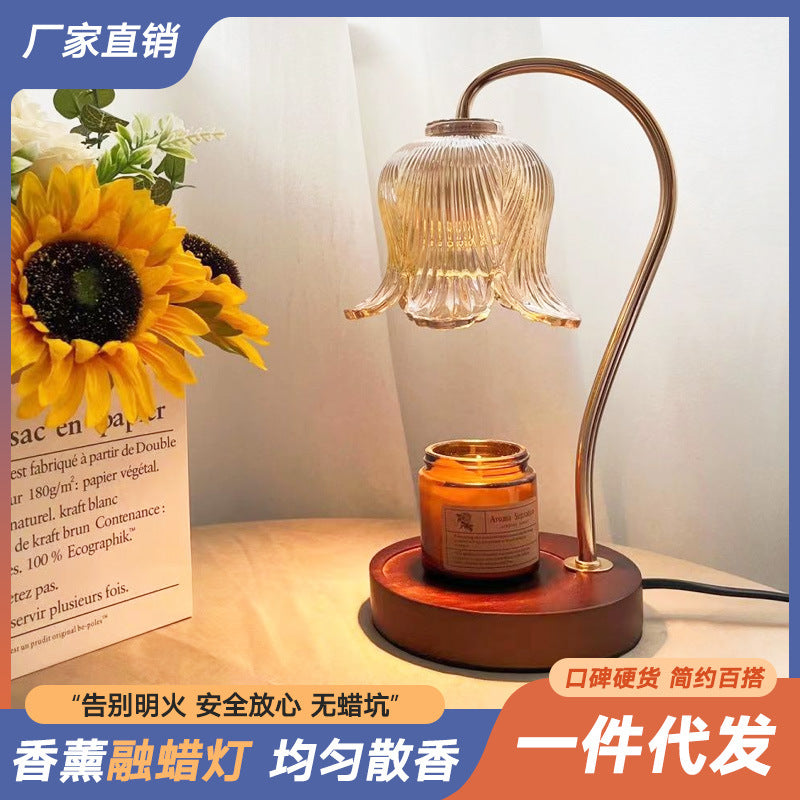 Wood-grain aroma diffuser with warm-lit bell glass shade, amber jar, and round base