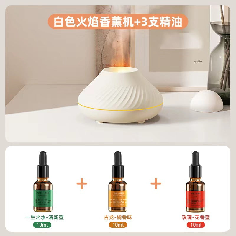 White flame aroma diffuser with orange flame effect and three essential oil bottles